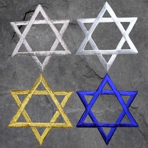 May include: Four embroidered Star of David patches in different colours: silver, gold, blue, and white. The patches are arranged in a grid pattern on a grey background.