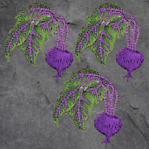 May include: Three embroidered beet patches. Each patch features a purple beet with green and purple leaves. The leaves have a detailed, textured appearance. The patches are set against a gray, stone-like background.
