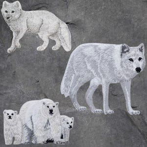 May include: Embroidered patches of arctic animals: an arctic fox, a wolf, and a polar bear with two cubs. The patches are white with detailed stitching, set against a grey background. Suitable for jackets, bags, or other fabric items.