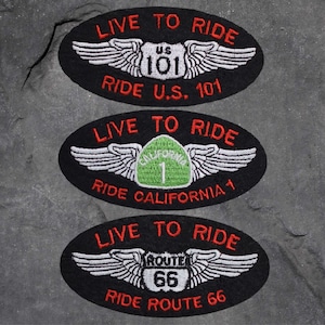 以下が含まれることがあります： 白い羽根と赤い文字がついた黒い楕円形の刺繍パッチが3つ。パッチには、US 101、カリフォルニア1、ルート66の異なる道路標識が描かれています。各パッチの文字は「Live to Ride」と道路番号です。