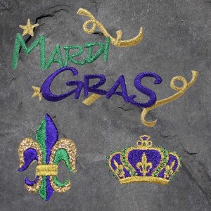 May include: Mardi Gras themed embroidery design with a purple, green, and gold fleur-de-lis, a crown, and the words "Mardi Gras" in purple and green.