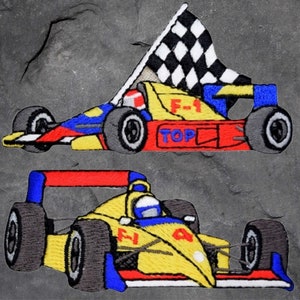 May include: Two embroidered patches of yellow and red race cars. The top patch features a checkered flag and the text "F-1 TOP". The bottom patch features the text "F1".