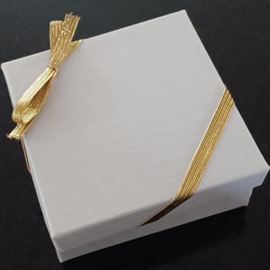 Gift packaging: The bracelet will arrive in a drawstring pouch with a white box and gold stretch ribbon on a card that says "Happy 50th Birthday".  It is beautifully packaged and ready to gift.