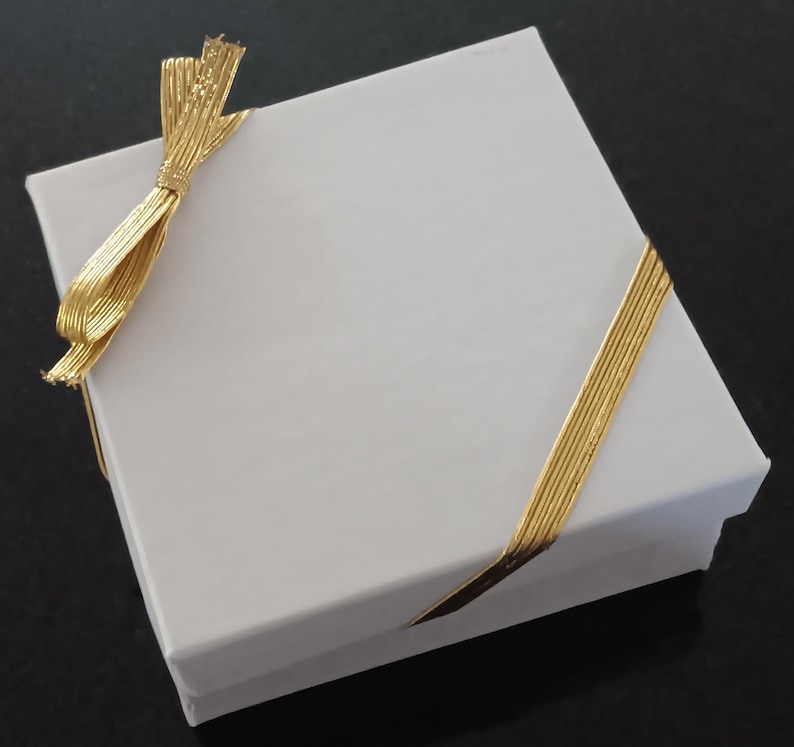 Gift packaging: The bracelet will arrive in a drawstring pouch with a white box and gold stretch ribbon on a card that says "Happy 50th Birthday".  It is beautifully packaged and ready to gift.