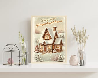 May include: A framed print depicting a snow-covered gingerbread house in a winter scene. The artwork has a warm colour palette and the text "Home sweet Gingerbread home" at the top. The print is displayed on a white shelf with decorative items.
