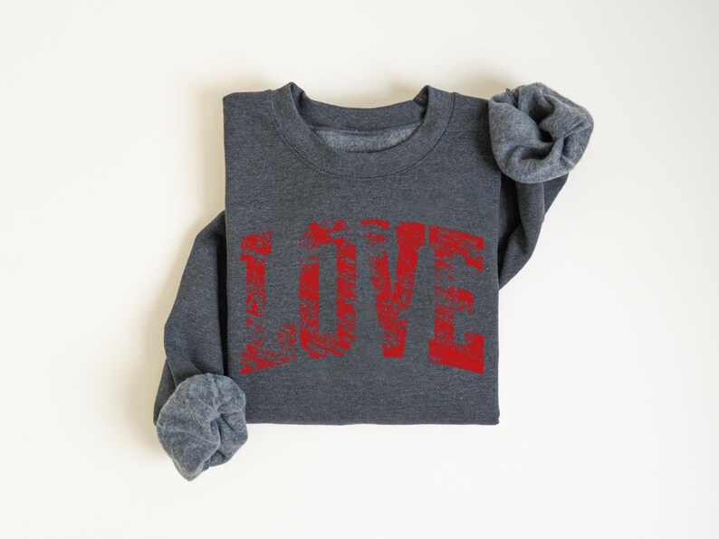 A gray sweatshirt with the word "LOVE" printed in red text on it.