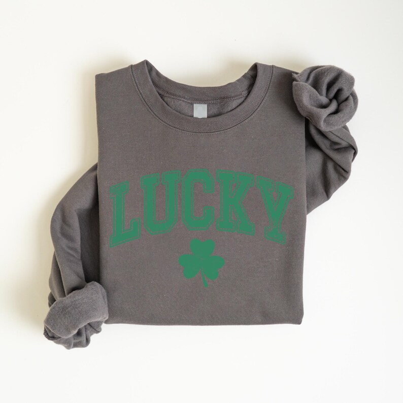 a gray shirt with a green lucky on it