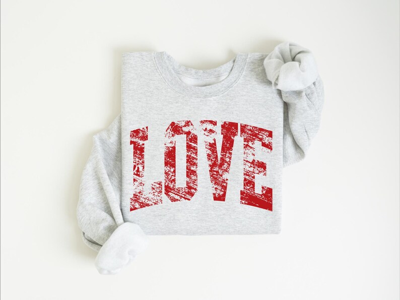 A gray sweatshirt with the word "LOVE" printed in red text on it.