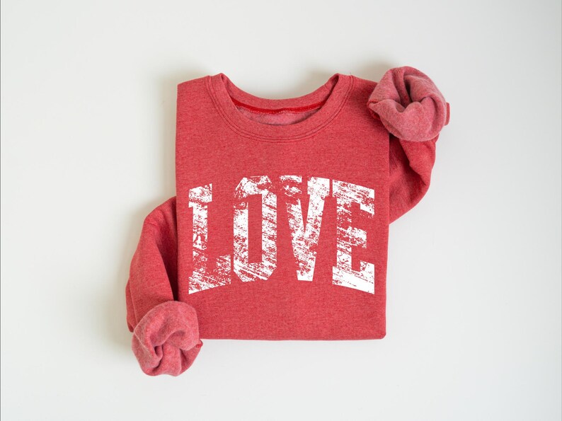 A red sweatshirt with the word "LOVE" printed in white text on it.
