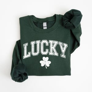 a green sweatshirt with a shamrock on it