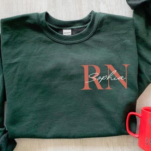 Personalized Registered Nurse Sweatshirt, Custom RN Swetshirt, Nurse Pocket Sweatshirt, Nurse Life Hoodie, Graduation Gifts for Nurses