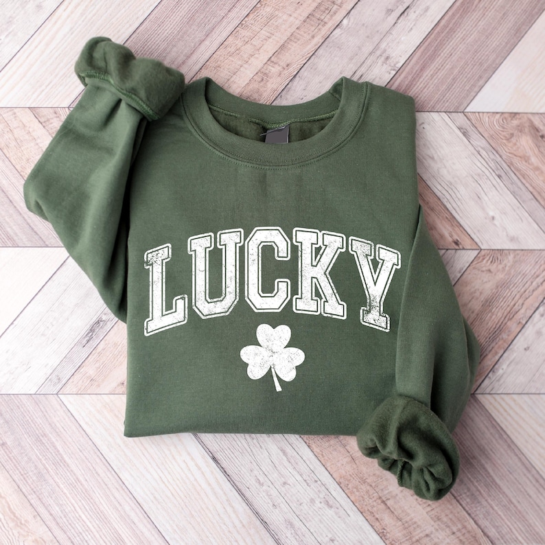 a green sweatshirt with lucky written on it