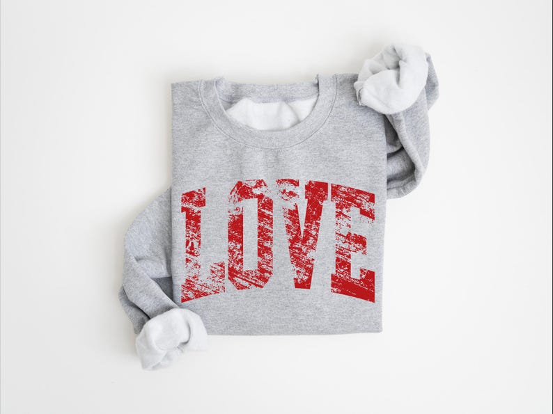 A gray sweatshirt with the word "LOVE" printed in red text on it.