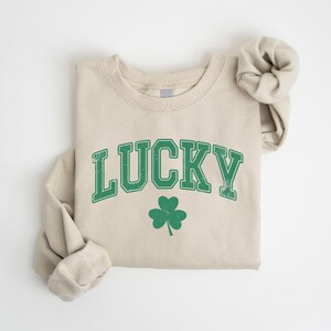 a white shirt with a green lucky on it