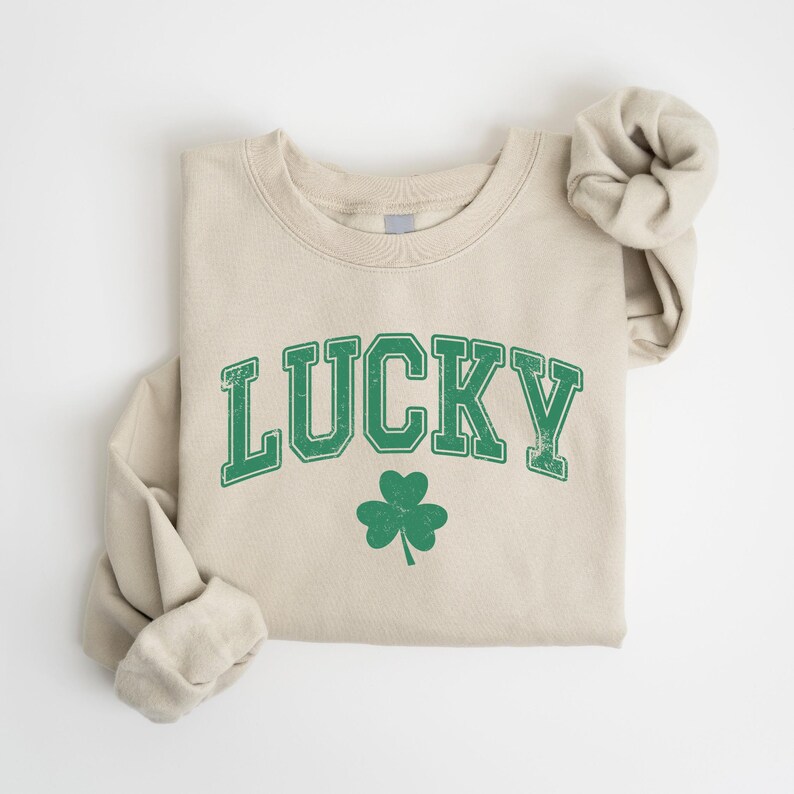 a white shirt with a green lucky on it