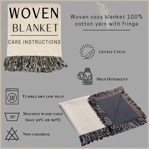May include: Woven blanket with fringe. The blanket is beige with black fringe and the text "WOVEN BLANKET" and "CARE INSTRUCTIONS". The blanket is made of 100% cotton yarn. Care instructions include gentle cycle, mild detergent, tumble dry low heat, machine wash cold, and non-chlorine.