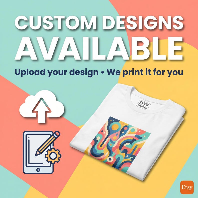 May include: White t-shirt with a colorful abstract design, folded on a yellow and teal background. The image includes the text "CUSTOM DESIGNS AVAILABLE" and "Upload your design &bull; We print it for you."