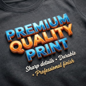 May include: Close-up of a dark gray t-shirt with the words "PREMIUM QUALITY PRINT" in 3D blue and orange lettering. Below, the text reads "Sharp details &bull; Durable &bull; Professional finish."