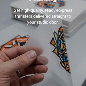 May include: Image features a stack of white paper with a colorful graphic transfer being peeled away. Text at the top reads "Skip the Complex Printing." The image promotes ready-to-press transfers delivered to your studio.