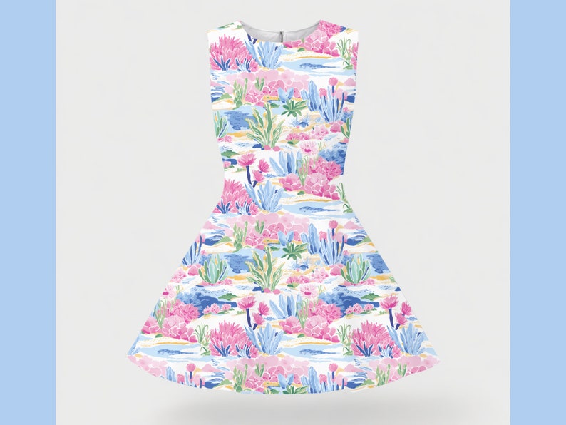 Puede incluir: Un vestido blanco sin mangas con estampado floral de flores rosas, azules y verdes. El vestido tiene un corpi&ntilde;o ajustado y una falda completa.