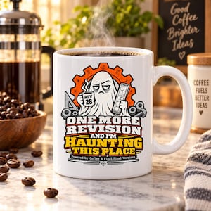 May include: A white ceramic mug featuring a graphic of a tired ghost holding a coffee cup labeled REV 28 and a blueprint. The text reads ONE MORE REVISION AND I'M HAUNTING THIS PLACE, with Powered by Coffee & Final Final Versions below it.