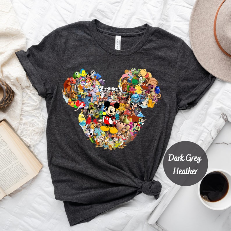 May include: Dark grey heather t-shirt with a Mickey Mouse head design made up of various Disney characters. The design includes Mickey Mouse, Minnie Mouse, Donald Duck, Goofy, Pluto, and many more.