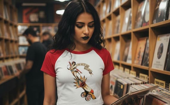 Pin-Up Circus Cannon Shirt | "I'm Out of Here" Retro Tattoo Flash Raglan Tee | Noir Carnival Women's Baby Tee