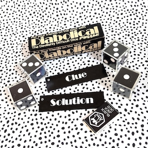 May include: A black and gold board game box with the title "Diabolical" and the text "The Devilishly Difficult Dice Puzzle". The box is surrounded by four black dice with white dots on a white background with black polka dots.