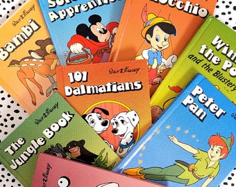 May include: A collection of vintage Walt Disney storybooks, including titles like "Pinocchio," "Peter Pan," and "101 Dalmatians." The books feature colorful illustrations and classic Disney characters on their covers. The books are arranged on a black and white polka dot surface.