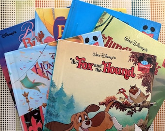 May include: A stack of vintage Disney children's books featuring The Fox and the Hound, The Hunchback of Notre Dame, and The Jungle Book. The books are all in good condition and have colorful covers.