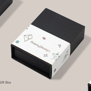 May include: A black gift box with a white label that says "PrismyDesign." The label features a geometric design with a diamond shape and other small illustrations.