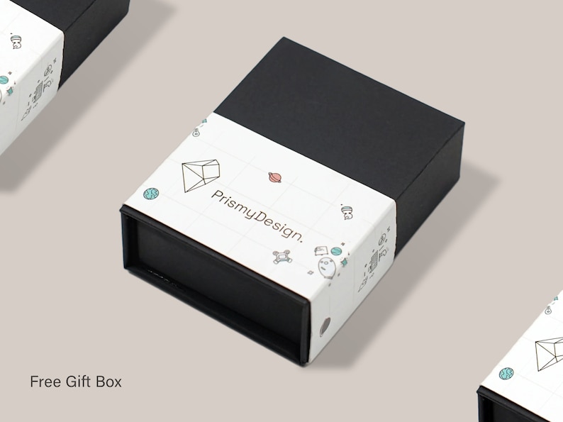 May include: A black gift box with a white label that says "PrismyDesign." The label features a geometric design with a diamond shape and other small illustrations.