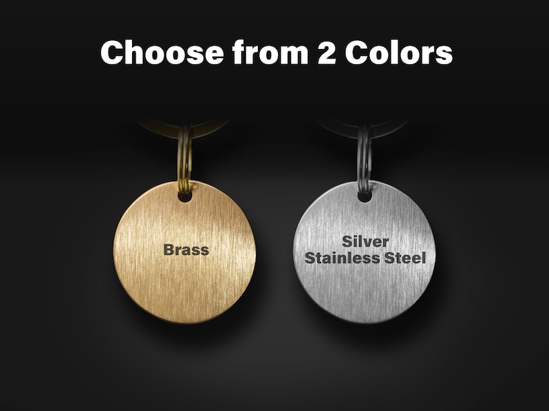May include: Two keyrings with round metal tags. The tag on the left is brass and says "Brass". The tag on the right is silver stainless steel and says "Silver Stainless Steel".