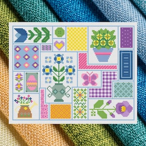 May include: A cross-stitch sampler featuring a patchwork design with floral, butterfly, and geometric patterns in pastel colors. The design includes a vase of flowers, an Easter egg, and a purple flower.