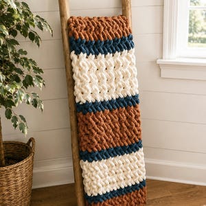Beginner-friendly chunky hand knit blanket video tutorial by Wistfully Woven featuring the Rustic Barn Weave stitch pattern in a soft sky blue color. Digital PDF download includes a 15+ minute step-by-step YouTube tutorial teaching how to make a cozy chunky knit blanket from cast on to cast off.