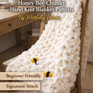 May include: A cream-colored, chunky hand-knit blanket with bee accents is draped over a wooden chair. The blanket features a honeycomb pattern and the text "Honey Bee Chunky Hand Knit Blanket Pattern" is visible. The blanket is beginner friendly.
