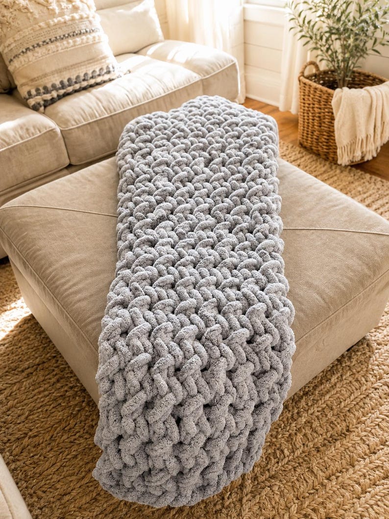 Beginner-friendly chunky hand knit blanket video tutorial by Wistfully Woven featuring the Rustic Barn Weave stitch pattern in a soft sky blue color. Digital PDF download includes a 15+ minute step-by-step YouTube tutorial teaching how to make a cozy chunky knit blanket from cast on to cast off.