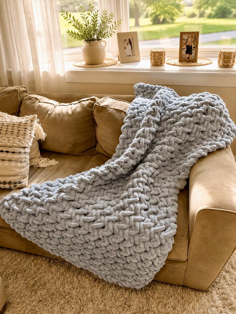 Beginner-friendly chunky hand knit blanket video tutorial by Wistfully Woven featuring the Rustic Barn Weave stitch pattern in a soft sky blue color. Digital PDF download includes a 15+ minute step-by-step YouTube tutorial teaching how to make a cozy chunky knit blanket from cast on to cast off.