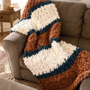 Beginner-friendly chunky hand knit blanket video tutorial by Wistfully Woven featuring the Rustic Barn Weave stitch pattern in a soft sky blue color. Digital PDF download includes a 15+ minute step-by-step YouTube tutorial teaching how to make a cozy chunky knit blanket from cast on to cast off.
