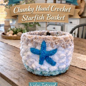 May include: A handmade, chunky crochet basket with a blue starfish applique. The basket features a white and tan textured design with a light blue base. Text on the image reads "Beginner Friendly, Chunky Hand Crochet Starfish Basket" and "Video Tutorial By Wistfully Woven."
