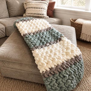 Beginner-friendly chunky hand knit blanket video tutorial by Wistfully Woven featuring the Rustic Barn Weave stitch pattern in a soft sky blue color. Digital PDF download includes a 15+ minute step-by-step YouTube tutorial teaching how to make a cozy chunky knit blanket from cast on to cast off.