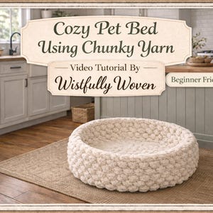 May include: A round, cream-colored pet bed made from chunky yarn sits on a woven rug. The bed is the focal point, with a kitchen background. Text on the image reads "Cozy Pet Bed Using Chunky Yarn" and "Video Tutorial By Wistfully Woven."