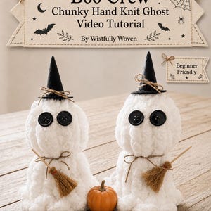 May include: Two white chunky hand-knit ghost figures with black button eyes, black felt witch hats, and small twine-tied brooms. A small orange pumpkin sits between them. A banner reads: Boo Crew Chunky Hand Knit Ghost Video Tutorial By Wistfully Woven.