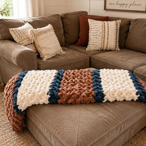 Beginner-friendly chunky hand knit blanket video tutorial by Wistfully Woven featuring the Rustic Barn Weave stitch pattern in a soft sky blue color. Digital PDF download includes a 15+ minute step-by-step YouTube tutorial teaching how to make a cozy chunky knit blanket from cast on to cast off.