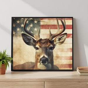 May include: A framed puzzle featuring a deer with large antlers, set against a backdrop of the American flag. The image has a vintage, distressed look, with the deer's head centered and the flag's stripes and stars visible.