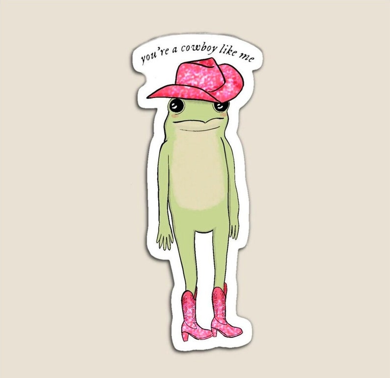 May include: A green frog wearing a pink cowboy hat and pink cowboy boots. The text "you're a cowboy like me" is written above the frog.