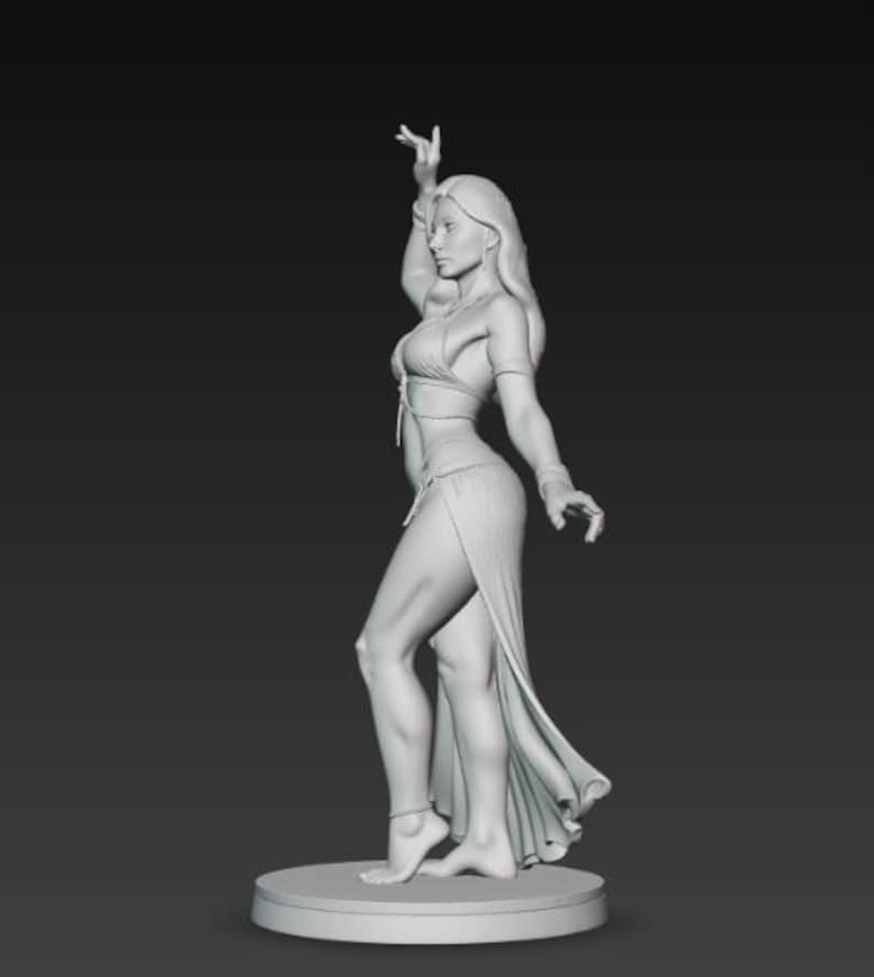 May include: A grayscale sculpture of a woman in a flowing, open-front skirt and a halter top, posed in a dance-like stance. Her arm is raised, and she is standing on a circular base. The sculpture has detailed features and is set against a dark background.