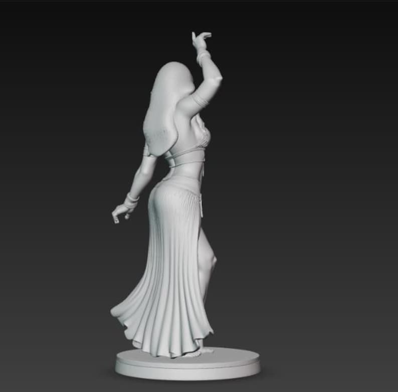 May include: A 3D-printed figurine of a dancer in a flowing skirt and a midriff-baring top. The dancer's arm is raised, and her hair cascades down her back. The figurine is in a neutral color and stands on a circular base.