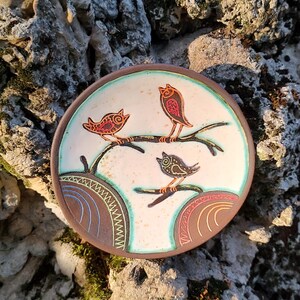 ceramic bird plate placed on stone rustic outdoor texture background