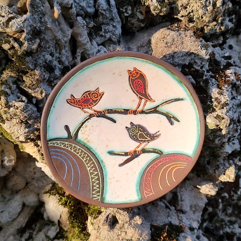 ceramic bird plate placed on stone rustic outdoor texture background